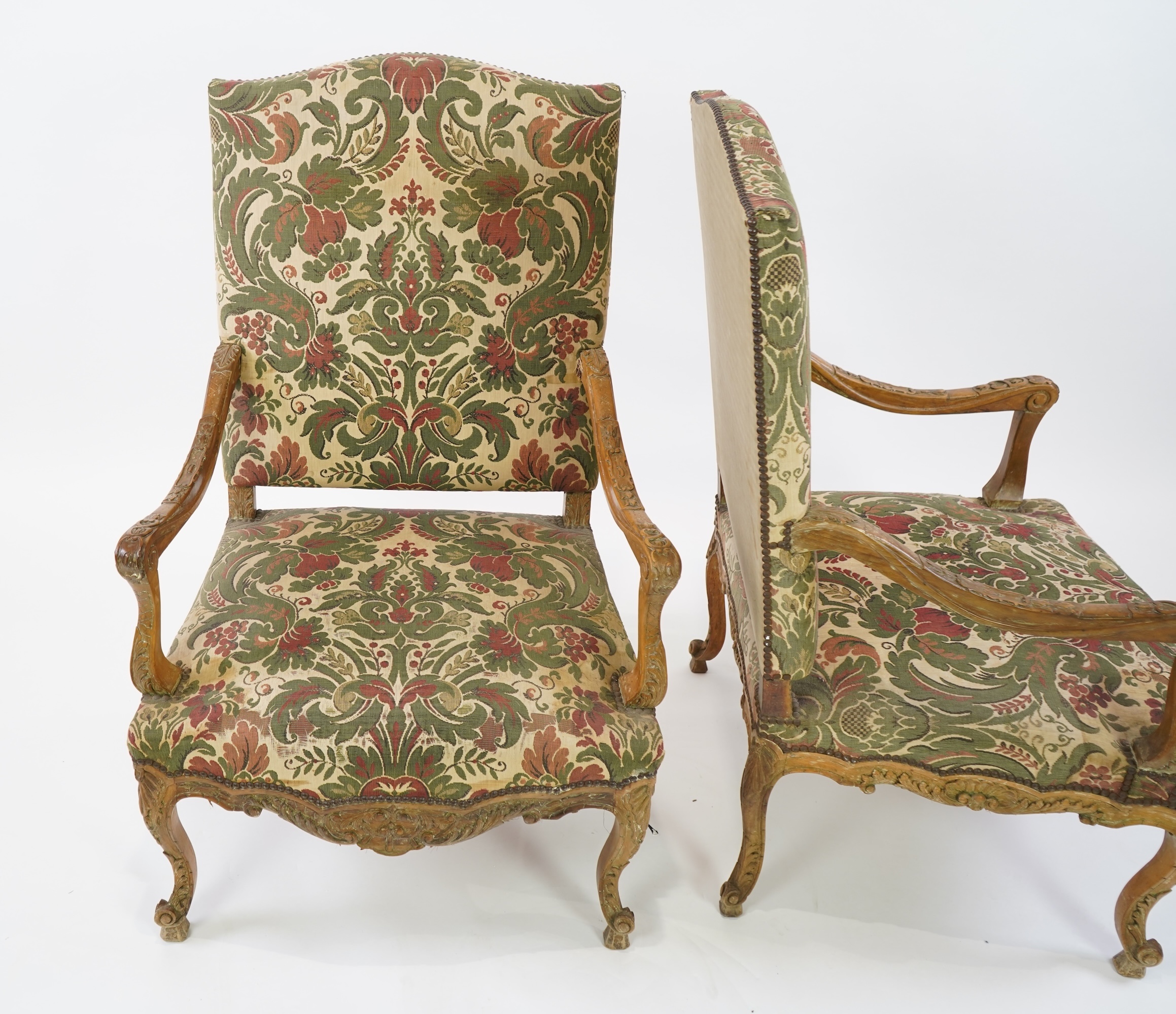 A pair of 19th century Louis XV style carved walnut grand fauteuil, with machined polychrome floral upholstery, outswept arms on cabriole legs, 74cm wide, 66cm deep, 116cm high, Provenance: The late Kenneth Turner (1936-